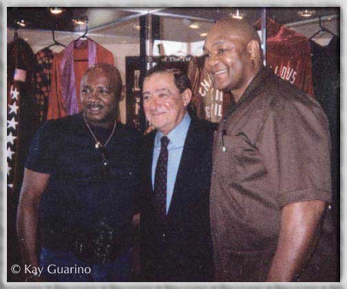 The Marvelous One with promoter Bob Arum,
and world heavyweight champion George Foreman.