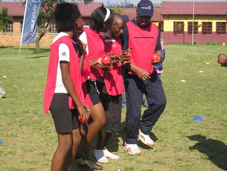 Sport and School education project in South Africa. Marvelous  and a part of the school kids team enjoy and play a game together